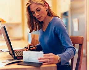 Woman looking at checkbook