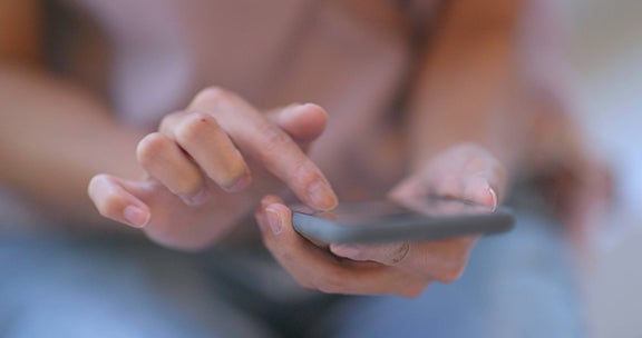 Hands holding cell phone